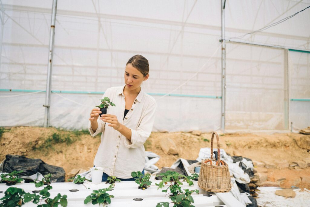 farming tech a dropdown filter and farming-related images including a woman working in a greenhouse.
