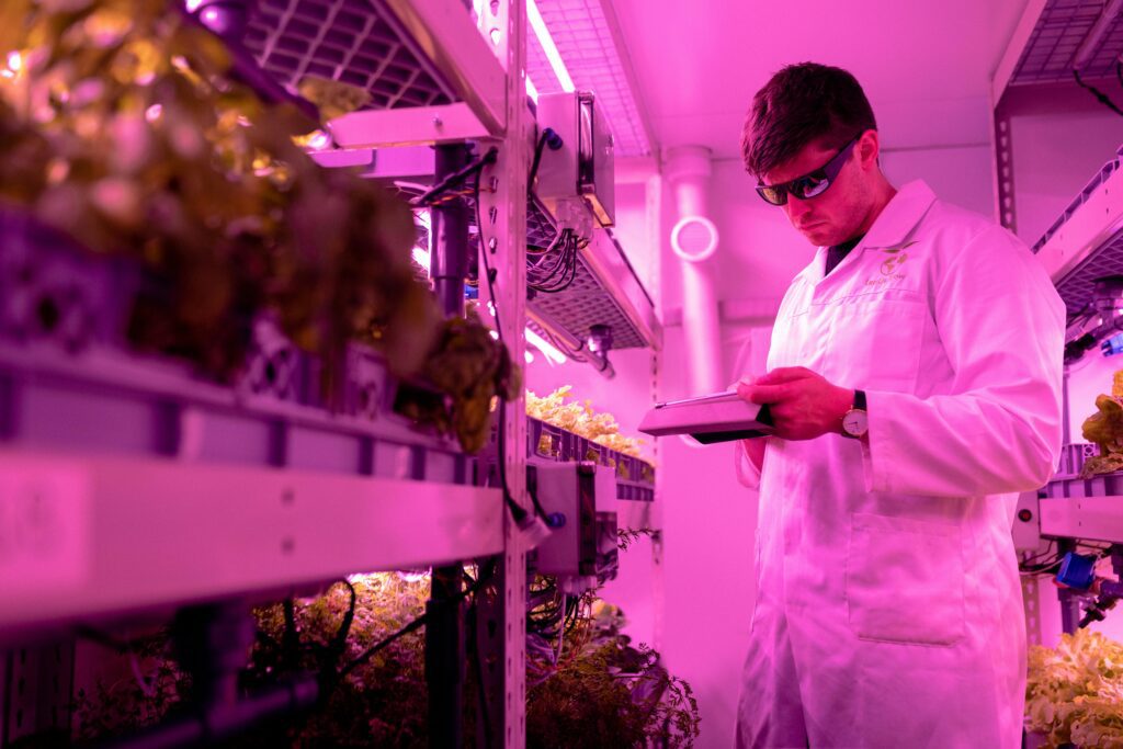 farm tech Alt Text
A media library screen showing a selected image of a person using a tablet in a pink-lit indoor farming or lab environment.